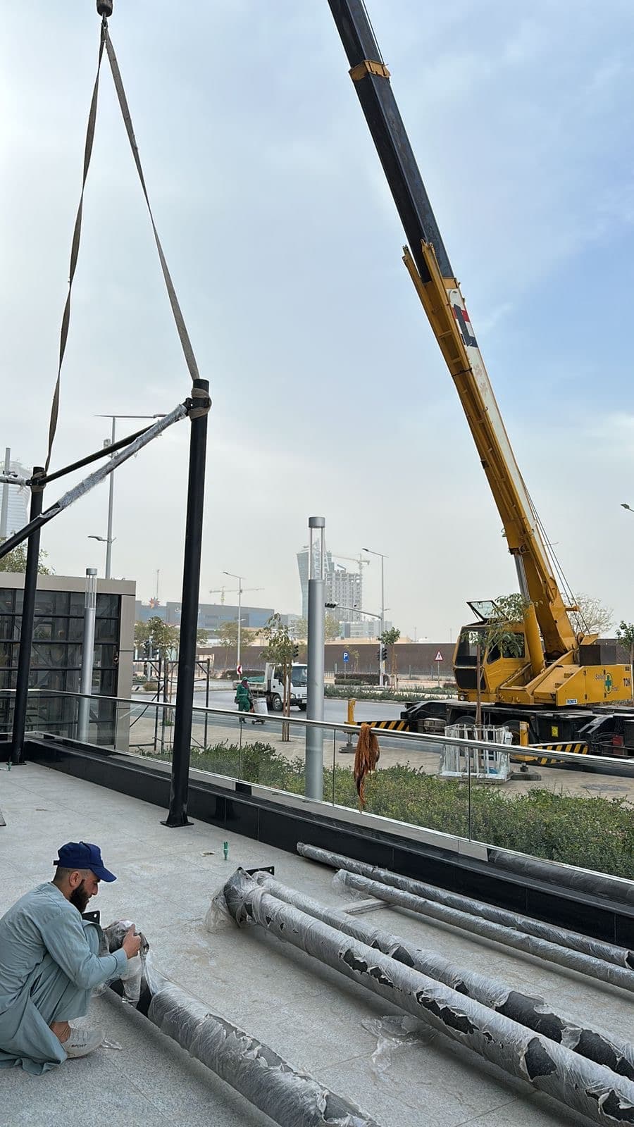 Crane lifting structural steel at the Longevity Wellness Hub site